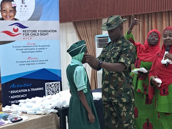 Lt Col OD Bamiteko Presenting Student With Medicated Glasses.