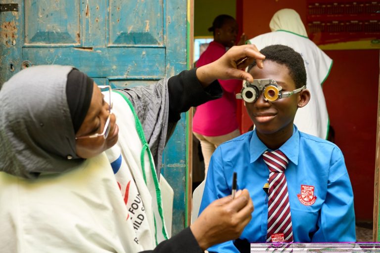 Dr. Alimi Conducting Vision Screening