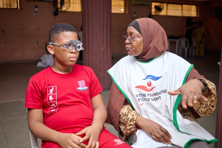 Dr. Alimi Conducting Vision Screening