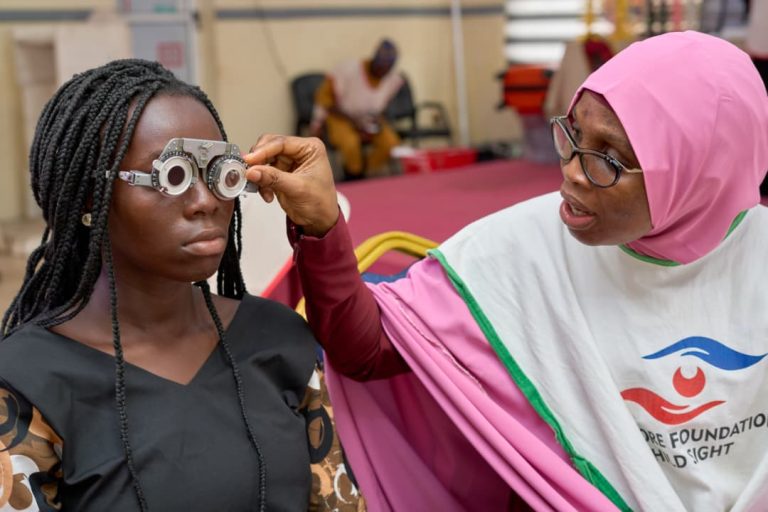 Dr. Akinremi Carrying out Vision Screening