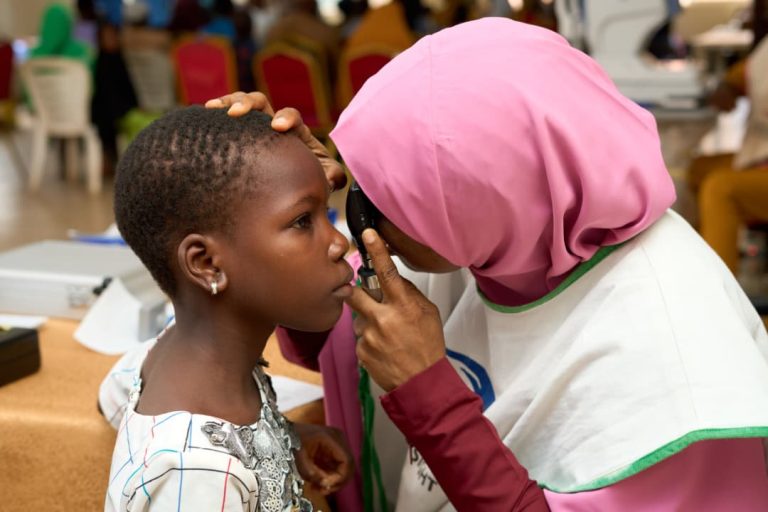 Dr. Akinremi Examining a Child
